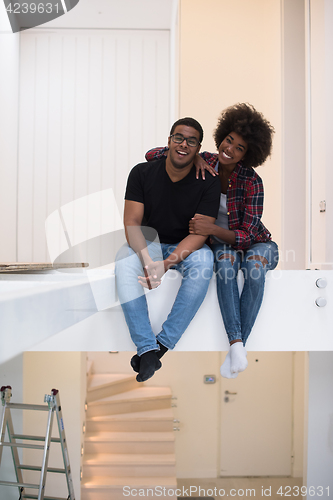 Image of couple having break during moving to new house