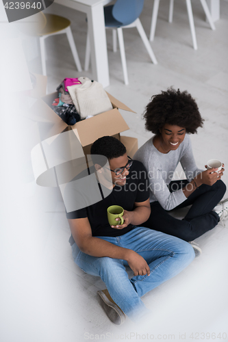 Image of African American couple relaxing in new house