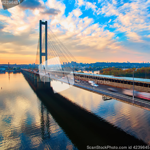 Image of Automobile and railroad bridge in Kiev, the capital of Ukraine. Bridge at sunset across the Dnieper River. Kiev bridge against the backdrop of a beautiful sunset in Kiev. Bridge in evening sunshine