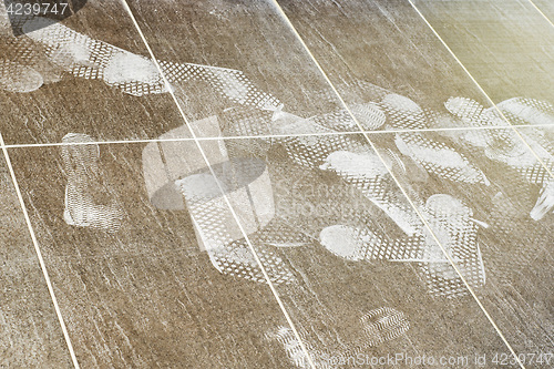 Image of Foot prints on the tiled floor