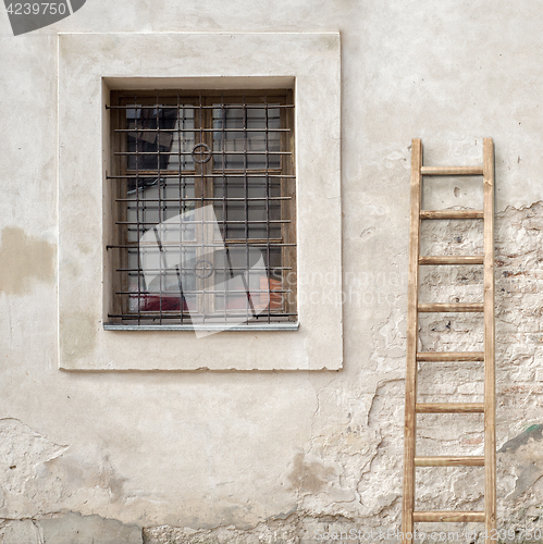 Image of abandoned cracked brick wall with a window