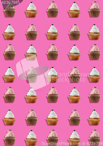 Image of Colorful pattern made of cupcakes on pink background.