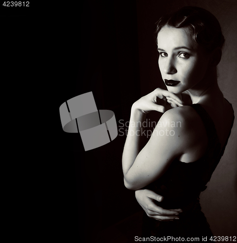 Image of beauty blond woman in studio on black background, stylish fashio