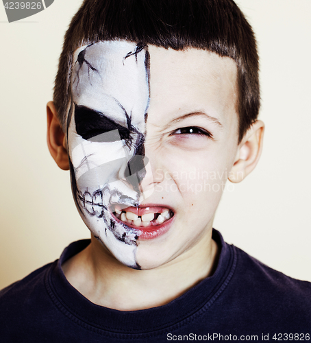 Image of little cute boy with facepaint like skeleton to celebrate hallow