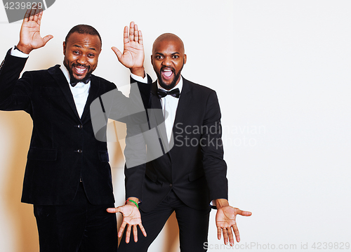 Image of two afro-american businessmen in black suits emotional posing, g