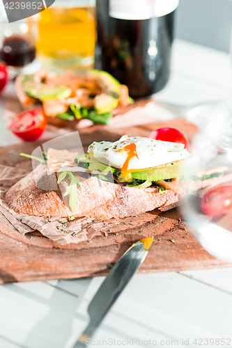 Image of Wine, baguette and cheese on wooden background