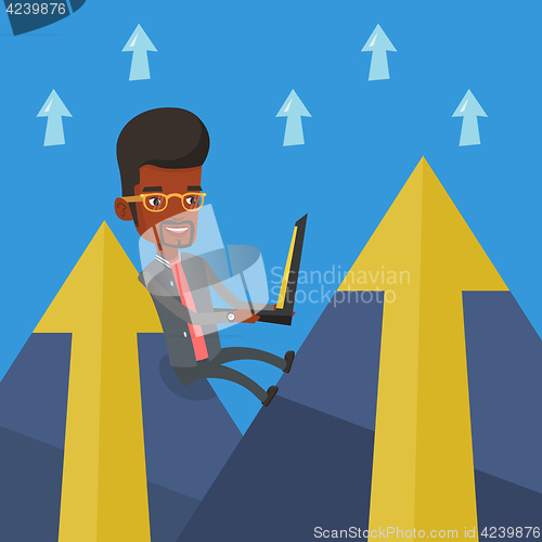 Image of Businessman working on laptop in the mountains.