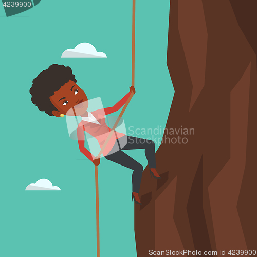 Image of Business woman climbing on the mountain.