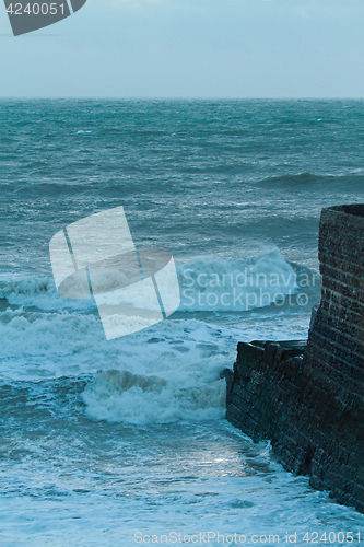 Image of Rough Sea and Jetty at Dusk