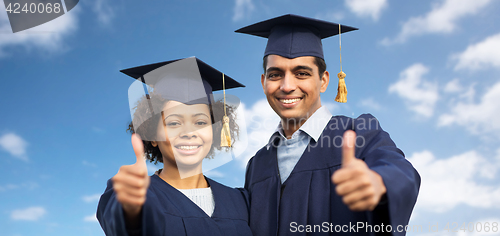 Image of happy students or bachelors showing thumbs up