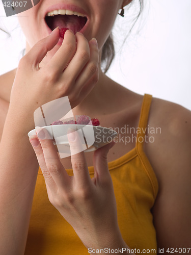 Image of Girl eating raspberry