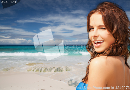 Image of happy smiling woman on summer beach