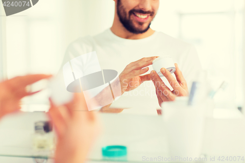 Image of close up of happy young man with cream at bathroom