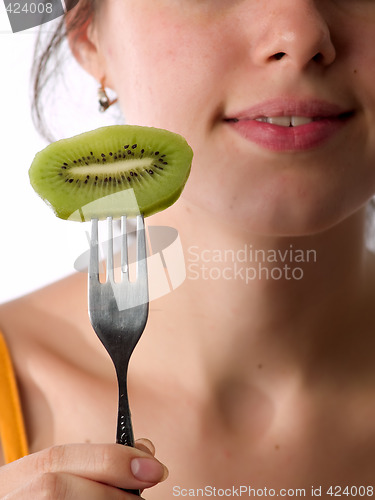 Image of Beautiful lady eats kiwi