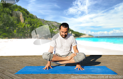 Image of man making yoga in scale pose outdoors