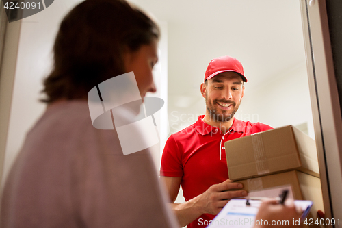 Image of deliveryman and customer with parcel boxes at home