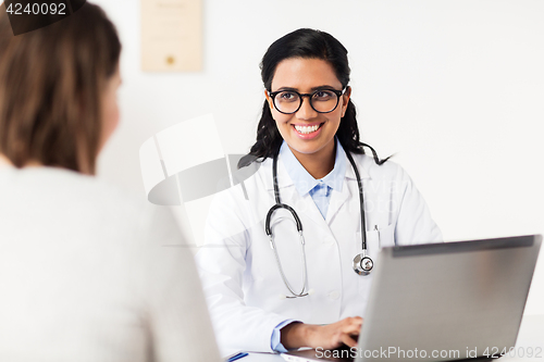 Image of doctor with laptop and woman patient at hospital