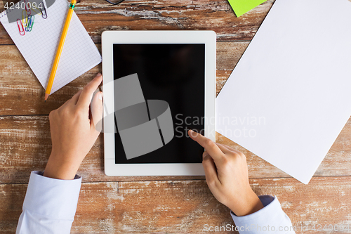 Image of close up of female hands with tablet pc on table