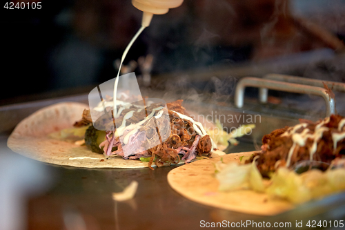 Image of tortilla wraps cooking at street market