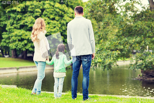 Image of family walking in summer park