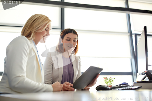 Image of businesswomen with tablet pc computer at office