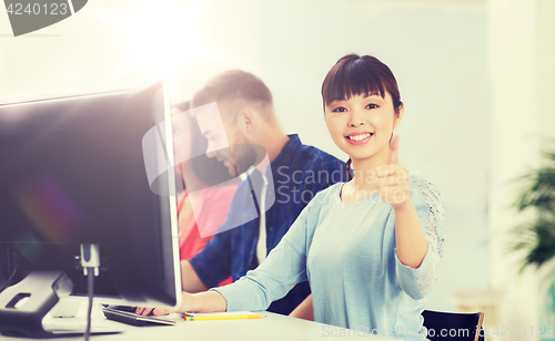 Image of happy creative team or students working at office