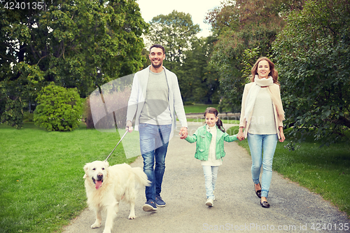 Image of happy family with labrador retriever dog in park