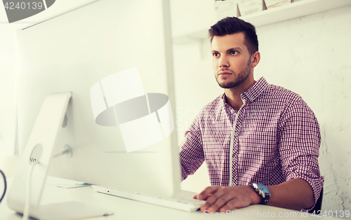 Image of creative man or student with computer at office