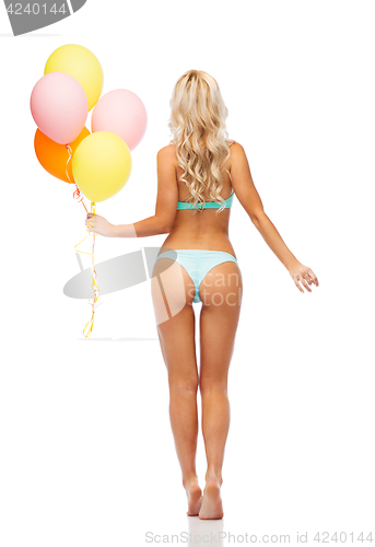 Image of woman in bikini swimsuit with air balloons