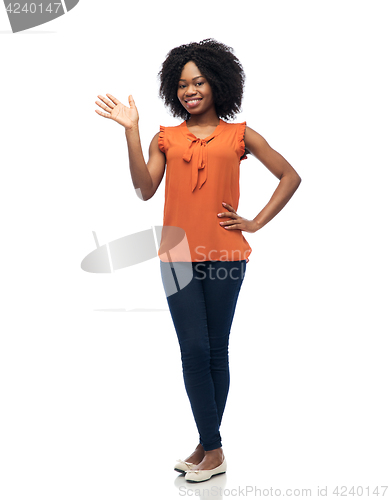 Image of happy african woman waving hand over white