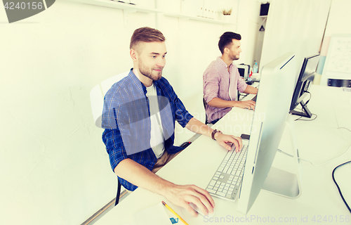 Image of creative man or student with computer at office