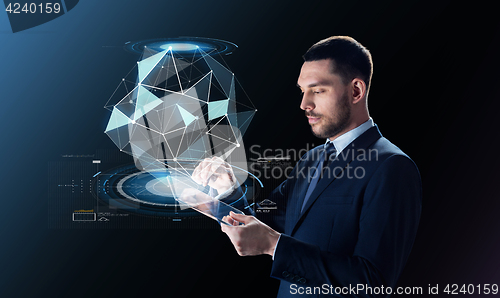 Image of businessman in suit with transparent tablet pc