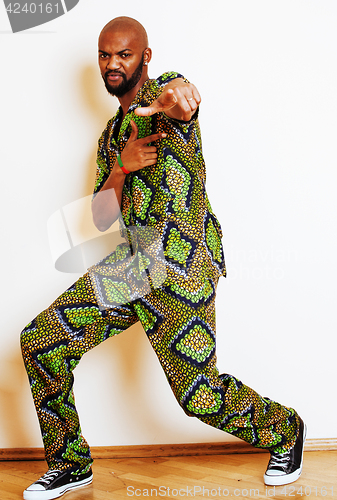 Image of portrait of young handsome african man wearing bright green nati