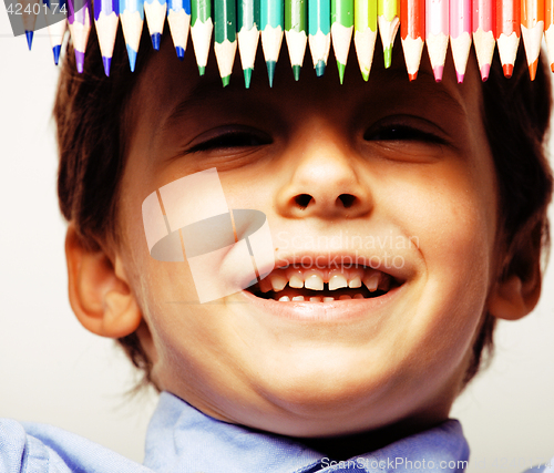 Image of little cute boy with color pencils close up smiling, education f