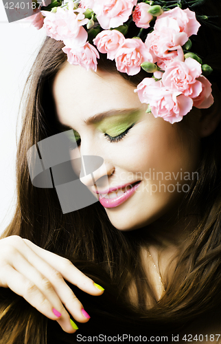 Image of Beauty young real woman with pink flowers and make up closeup, s