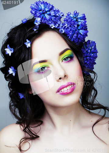 Image of Beauty young woman with flowers and make up close up, real sprin