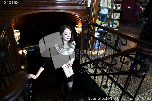 Image of young elegant brunette woman in cafe drinking coffee, luxury int