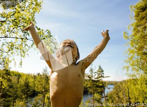 Image of little cute real boy among tree hight, outdoor lifestyle people 