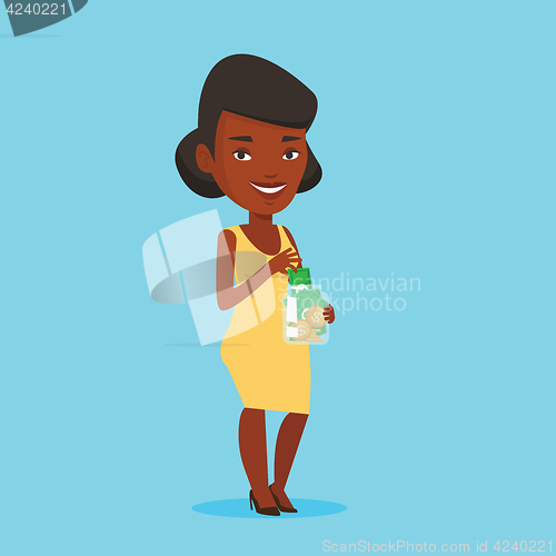 Image of Business woman putting dollar money into money jar