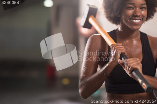 Image of black woman after workout with hammer