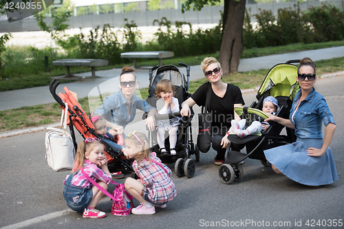 Image of mother with children in the park