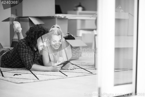 Image of Young couple moving in a new flat