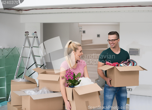 Image of young couple moving into a new home