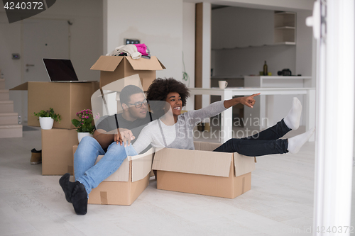 Image of African American couple  playing with packing material