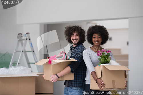 Image of multiethnic couple moving into a new home