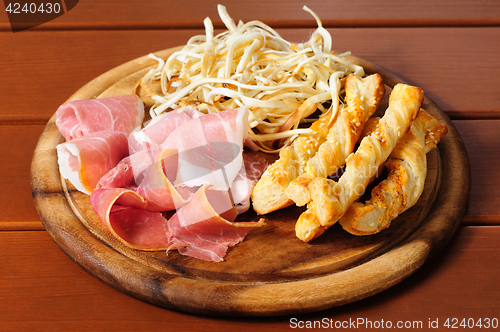 Image of Beer snacks on wooden plate