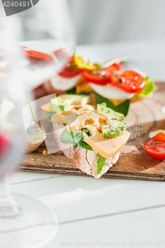 Image of The baguette and cheese on wooden background