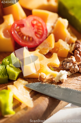 Image of The baguette and cheese on wooden background