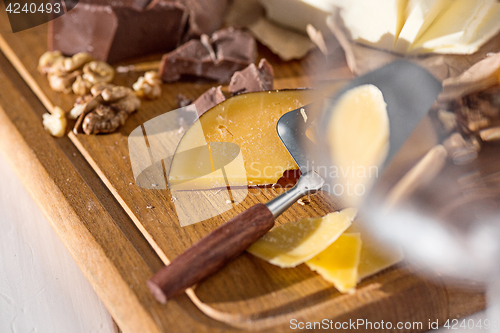 Image of The different kind of cheese and walnuts on wooden background