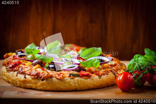 Image of Traditional homemade pizza with tomatoes and olives